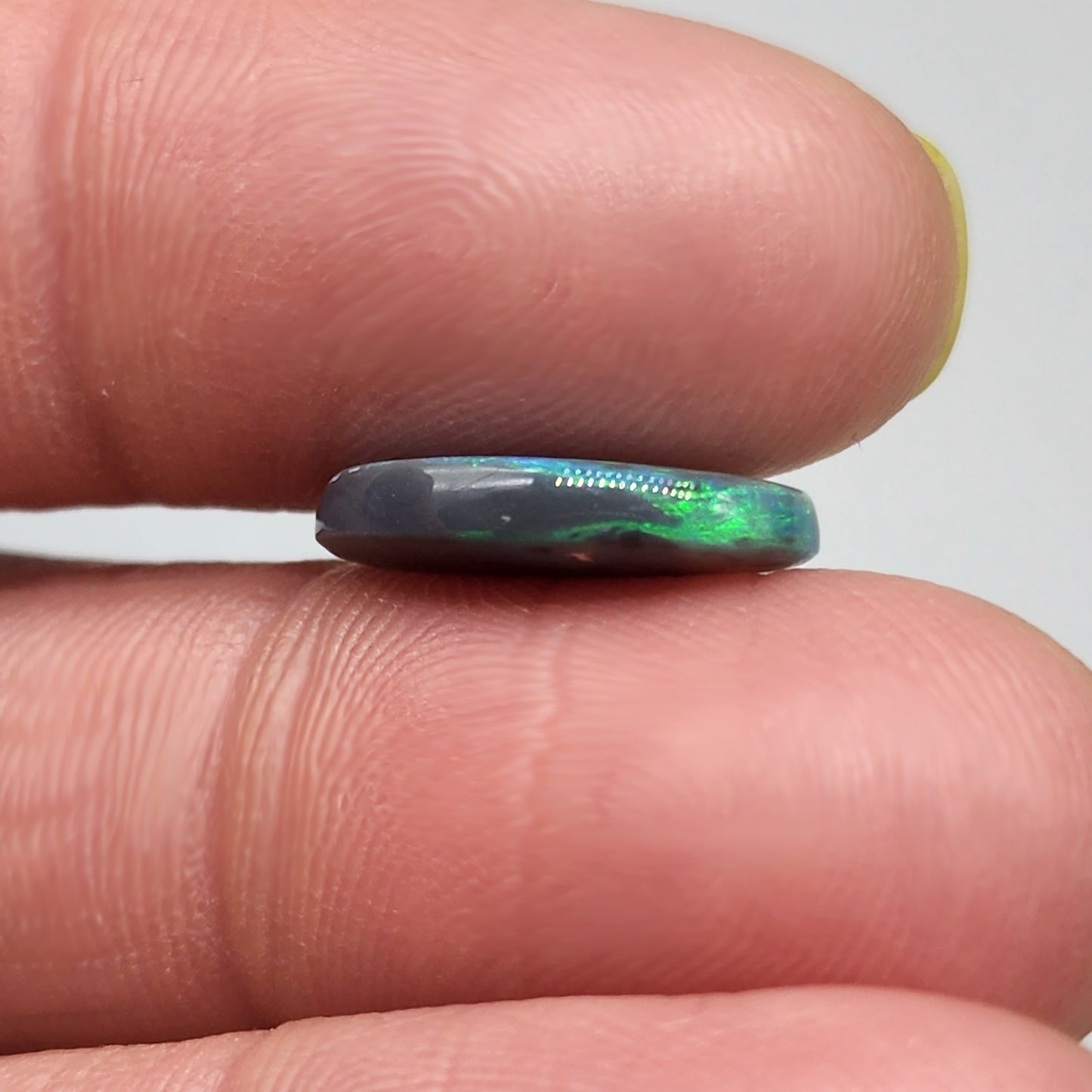 4cts Black Opal with a very Earth like color pallet, small soft patterns with vivid saturation