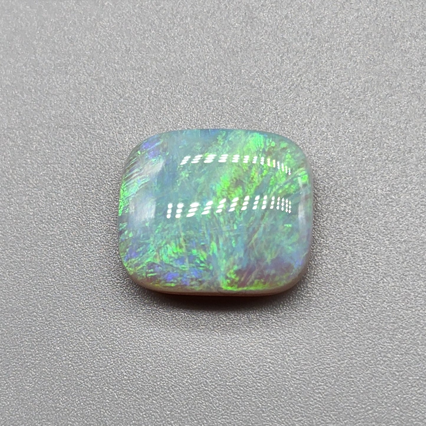 6.8cts Semi Black Opal with a lovely well dispersed moss pattern with green and yellow color play