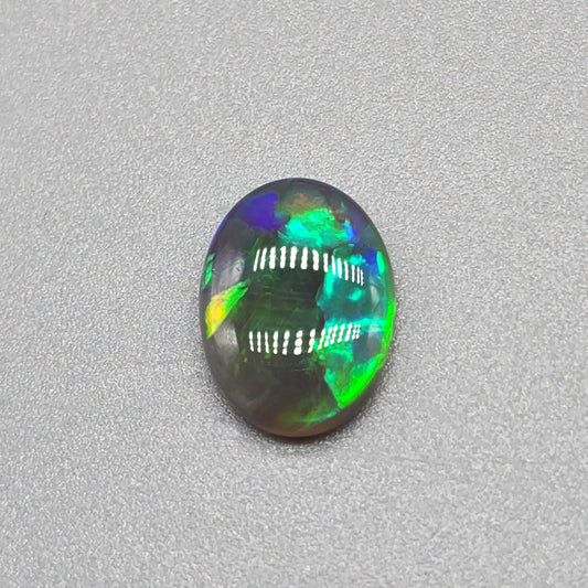 1.6cts Black Opal with a vivid green/blue color pallet and sharp aesthetic pattern