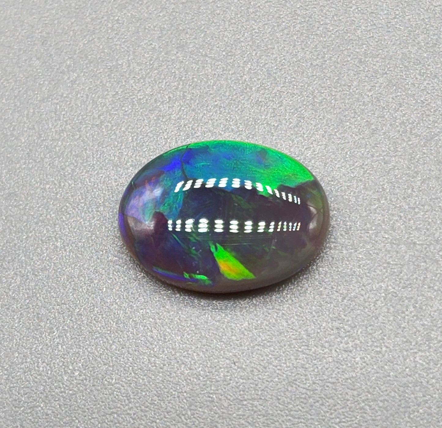 1.6cts Black Opal with a vivid green/blue color pallet and sharp aesthetic pattern