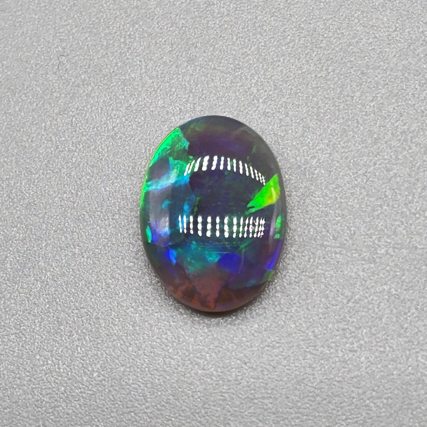 1.6cts Black Opal with a vivid green/blue color pallet and sharp aesthetic pattern