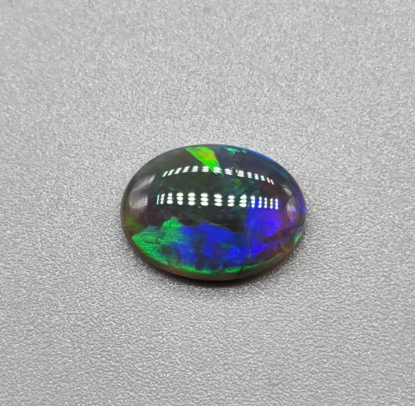 1.6cts Black Opal with a vivid green/blue color pallet and sharp aesthetic pattern