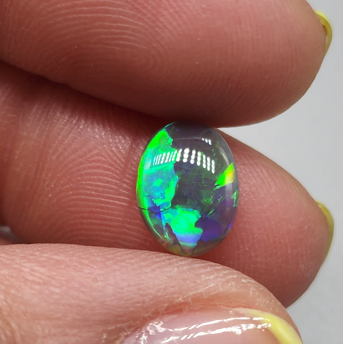 1.6cts Black Opal with a vivid green/blue color pallet and sharp aesthetic pattern