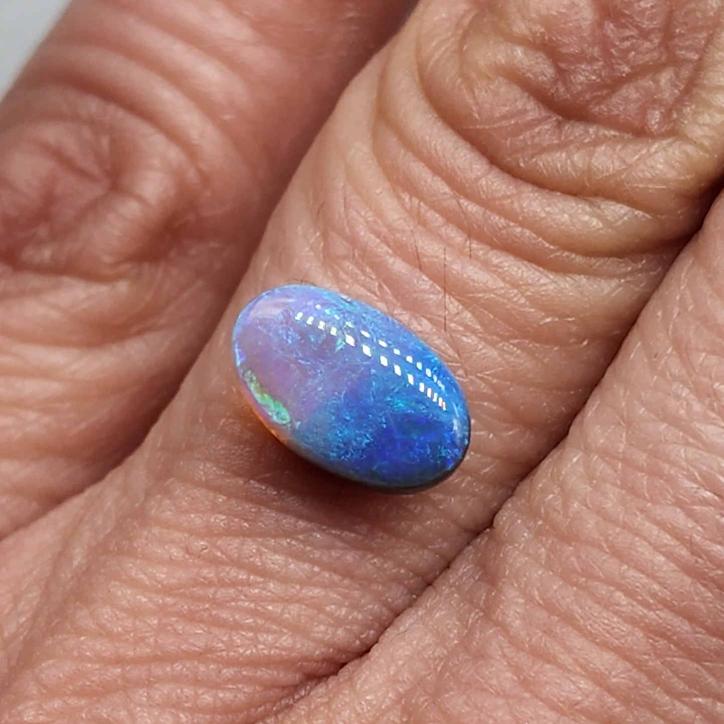 2.4cts Dark opal with an oceanic presence.