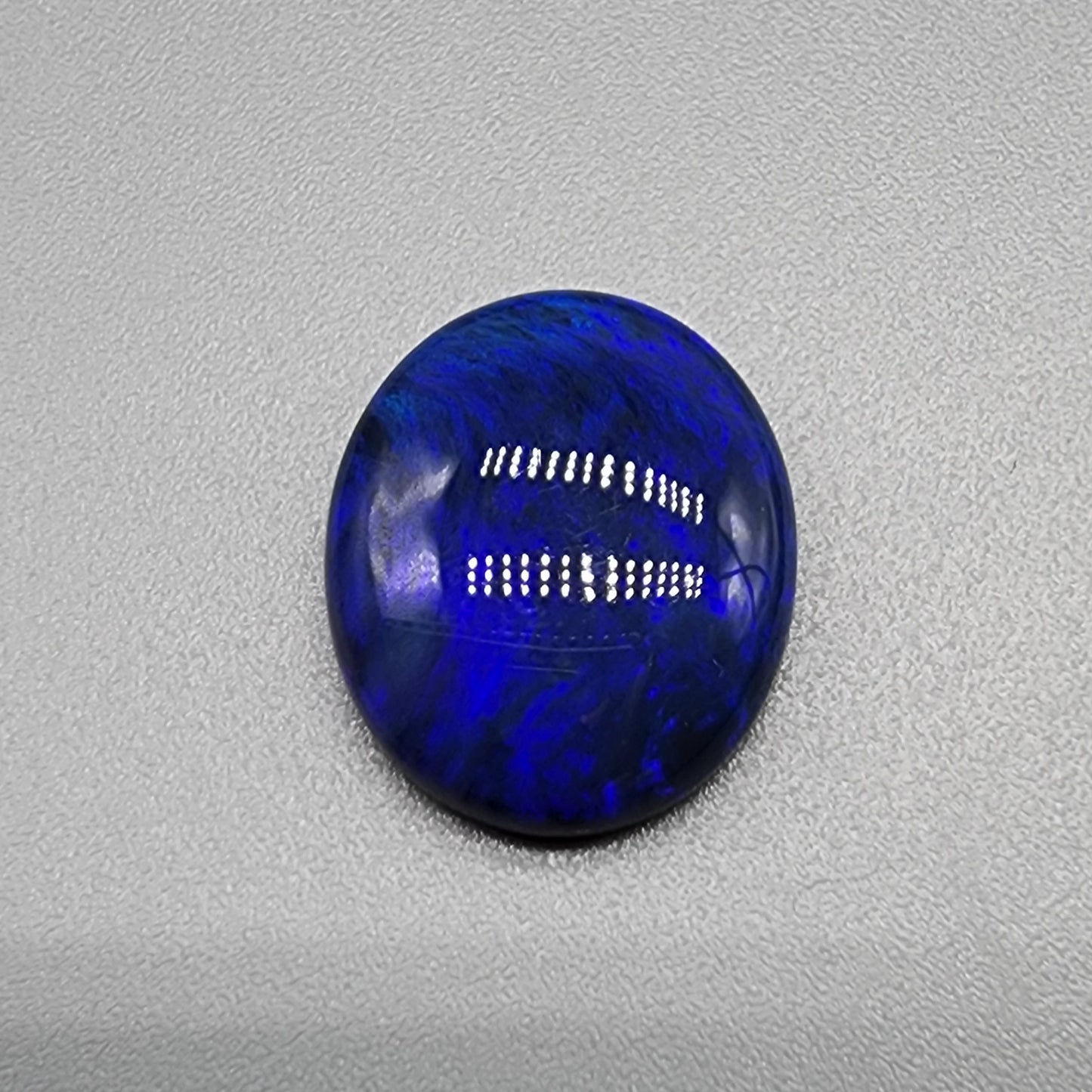 4.9cts Black Opal with well dispersed royal blue play of color