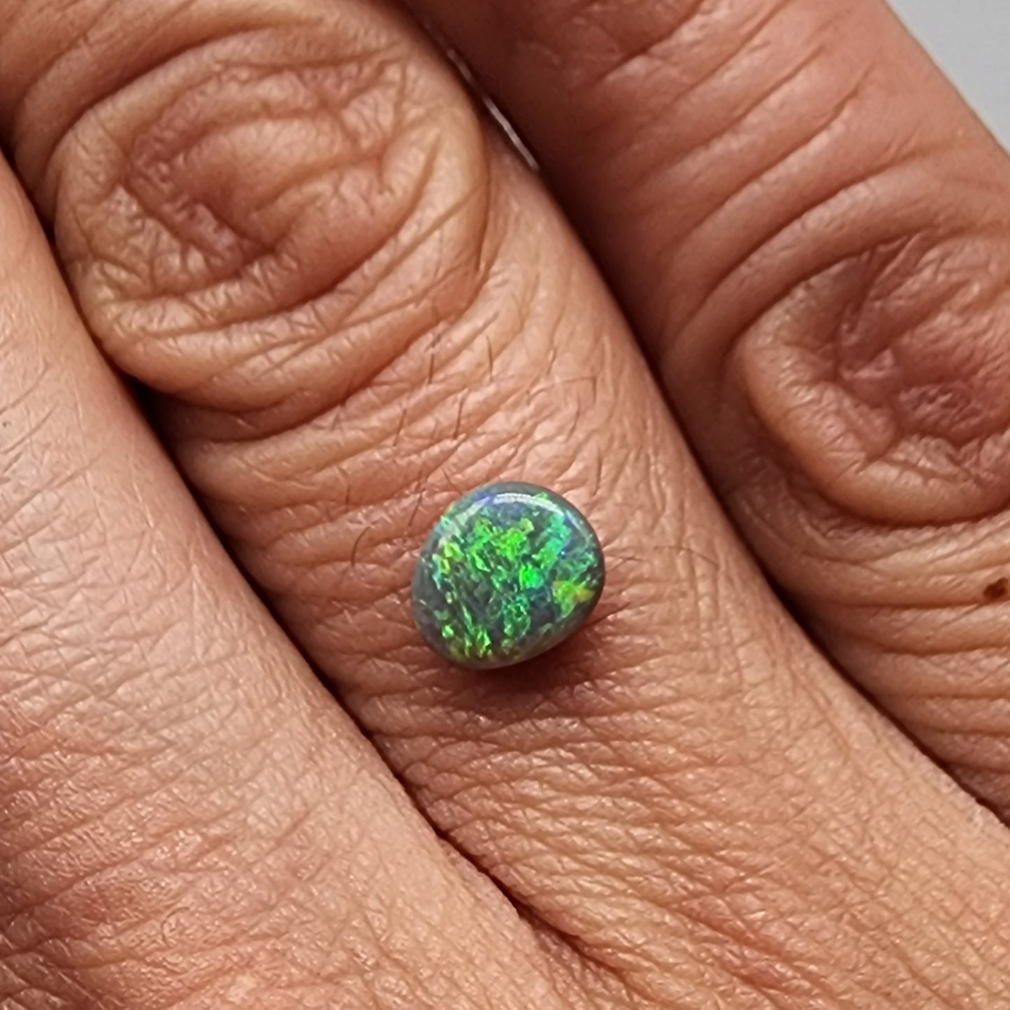 0.75cts  Black Opal with a green dominated mossy pattern and nice color dispersal