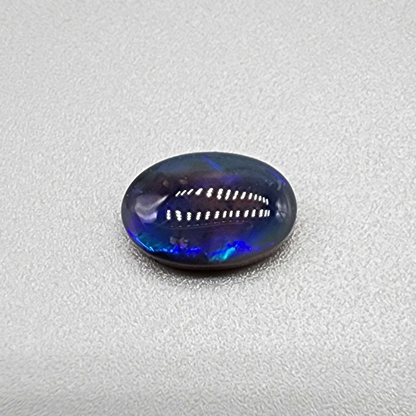 1.85cts  Black Crystal Opal with vivid but directional purple-blue  color play