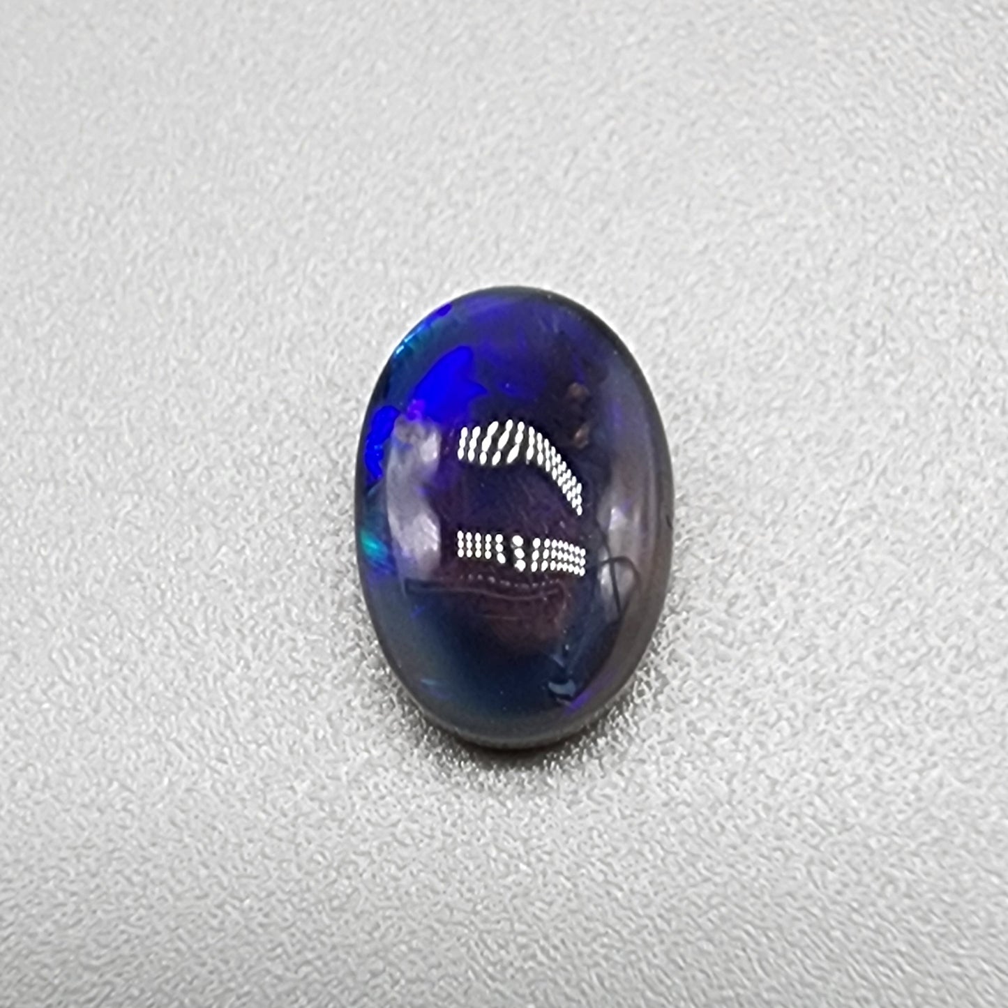 1.85cts  Black Crystal Opal with vivid but directional purple-blue  color play