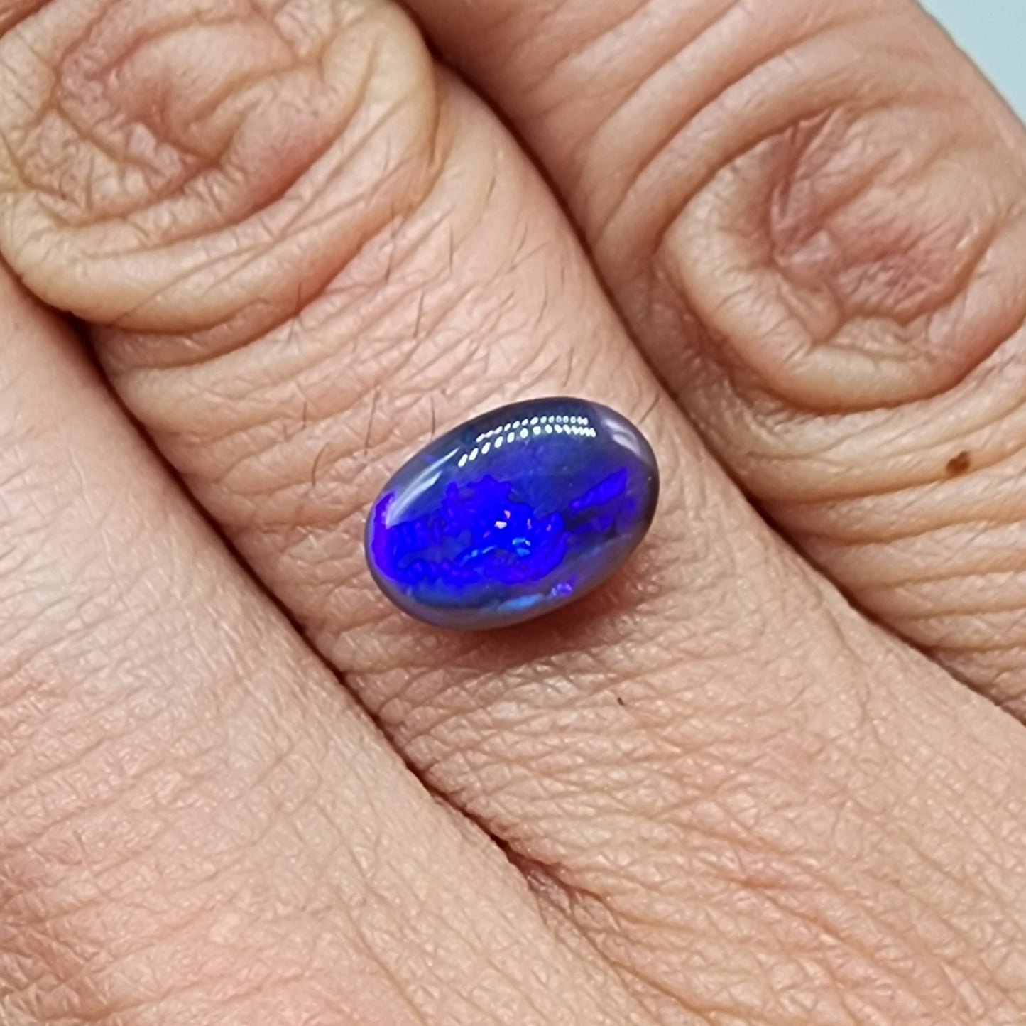 1.85cts  Black Crystal Opal with vivid but directional purple-blue  color play