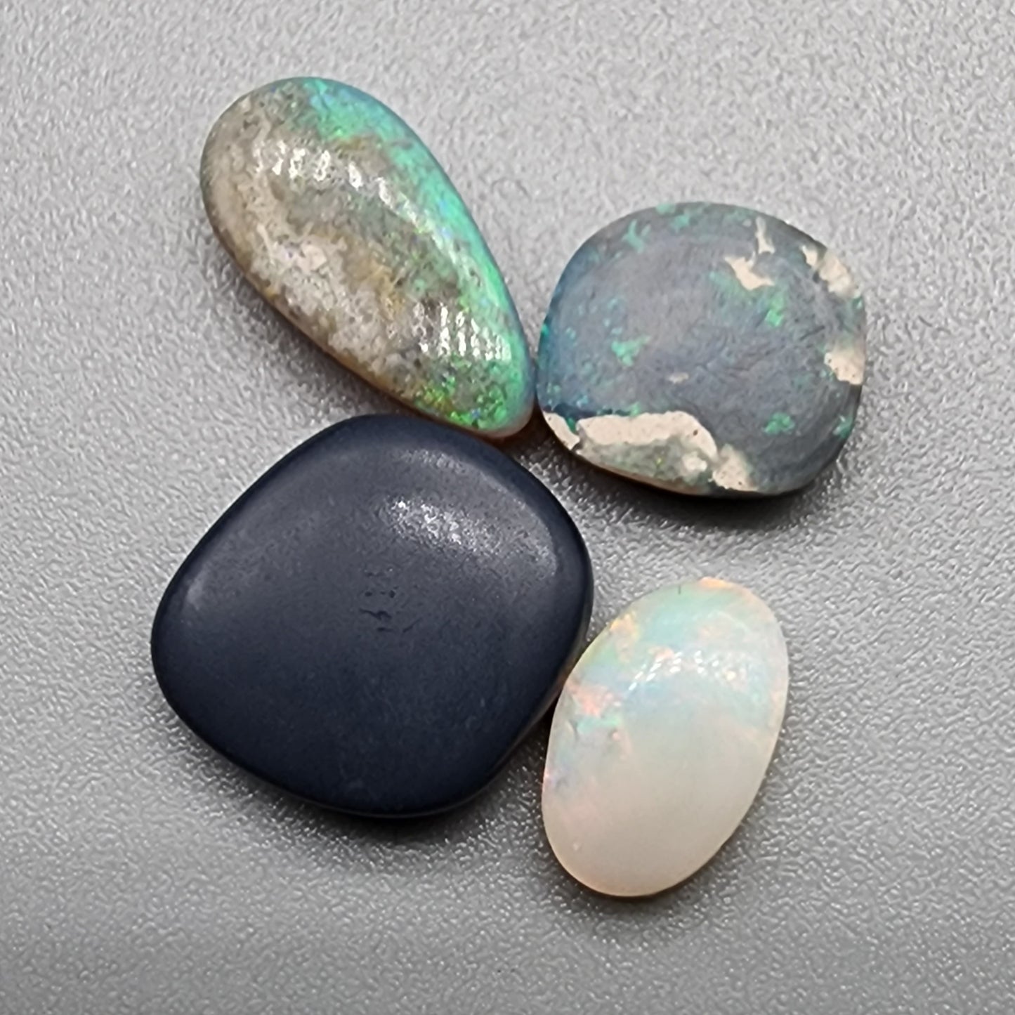 Assorted freeform Dark opal and Black Opals, all have excellent patterning and full faced color.