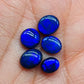 Assorted Black Opals with royal blue color play on a jet black base