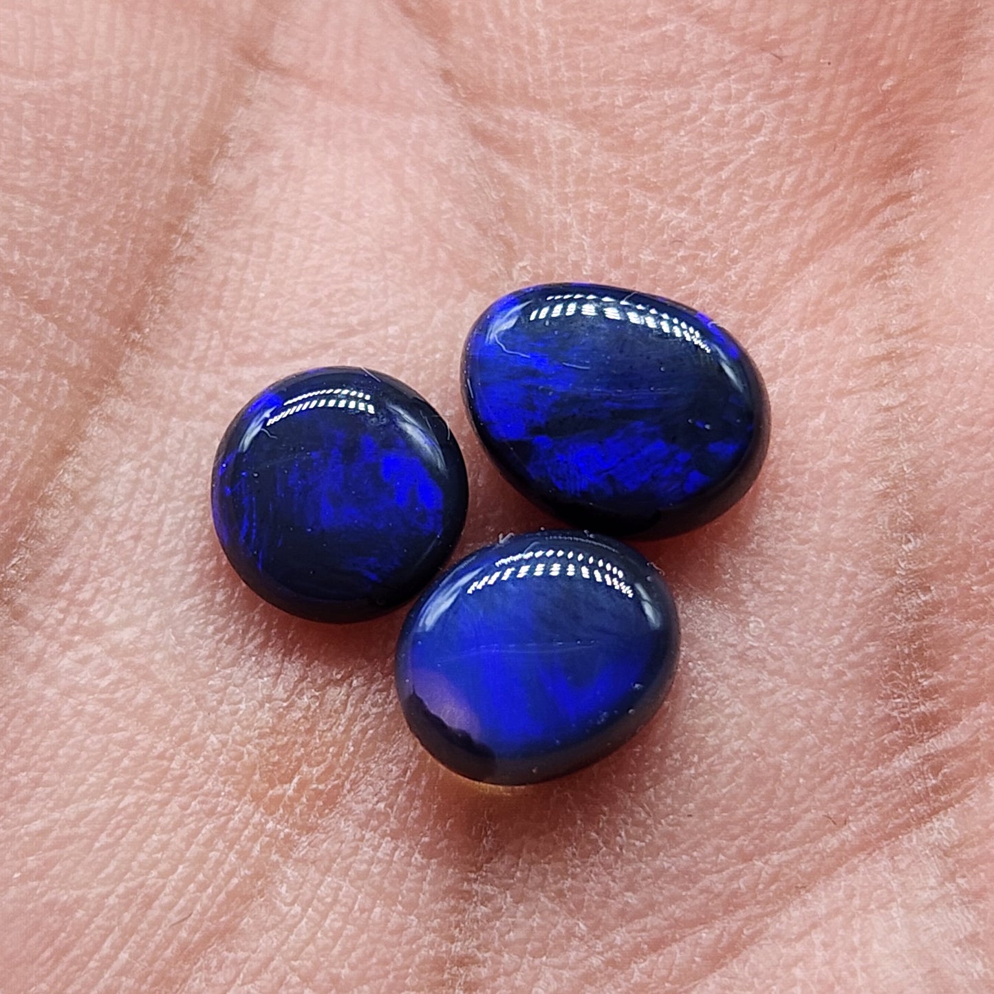 Assorted Black Opals with jet black base color and royal blue play of color