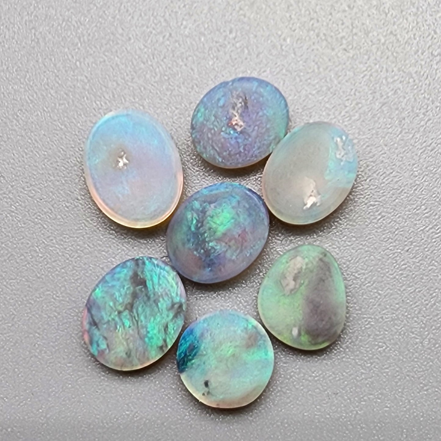 Assorted  Crystal opals  with a minty green color pallet and mossy patterns.