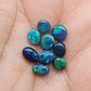 An assortment of accessible black opals with an attractive array of blues, greens and teals