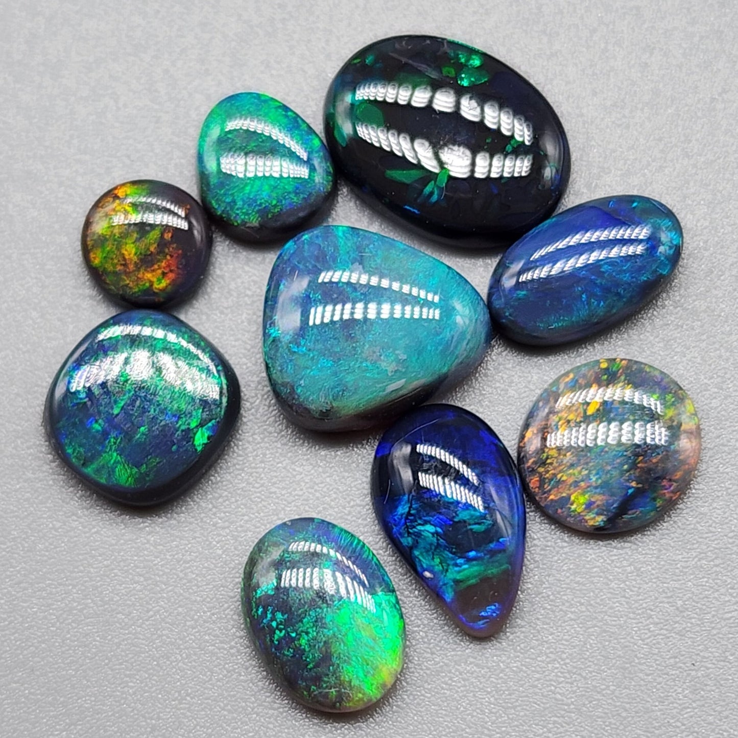 Assorted Black and Dark Opals with vivid colors, swirled with black potch giving the stones a lovely contrast and character